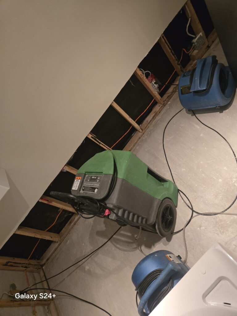 Air movers and dehumidifiers drying a water-damaged home in Toronto.